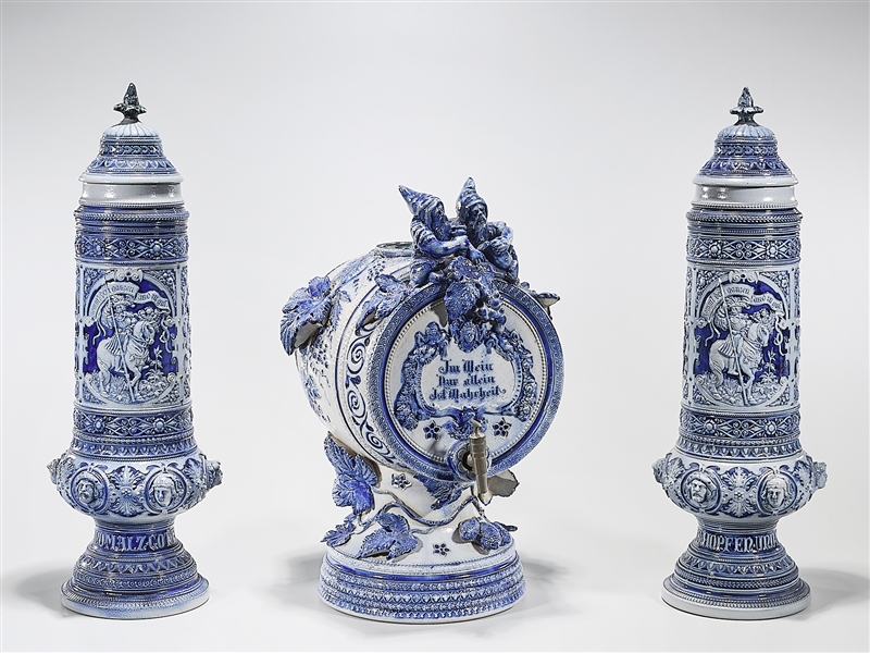 Appraisal: Blue and white ceramic German-style model beer steins and keg