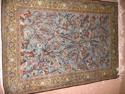 Appraisal: A KERMAN RUG the blue field depicting various birds on