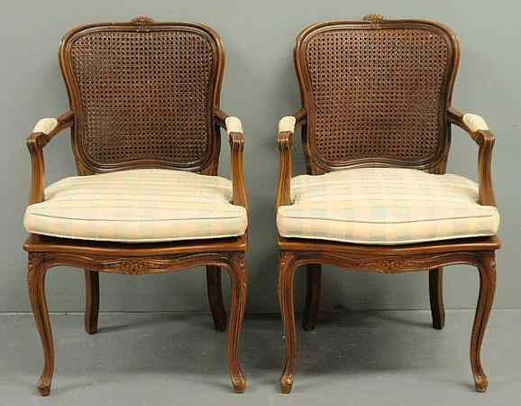 Appraisal: Pair of French fruitwood fauteuils th c with caned backs