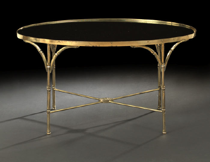 Appraisal: Contemporary Gilt-Metal and Smoked Glass Cocktail Table the inset oval