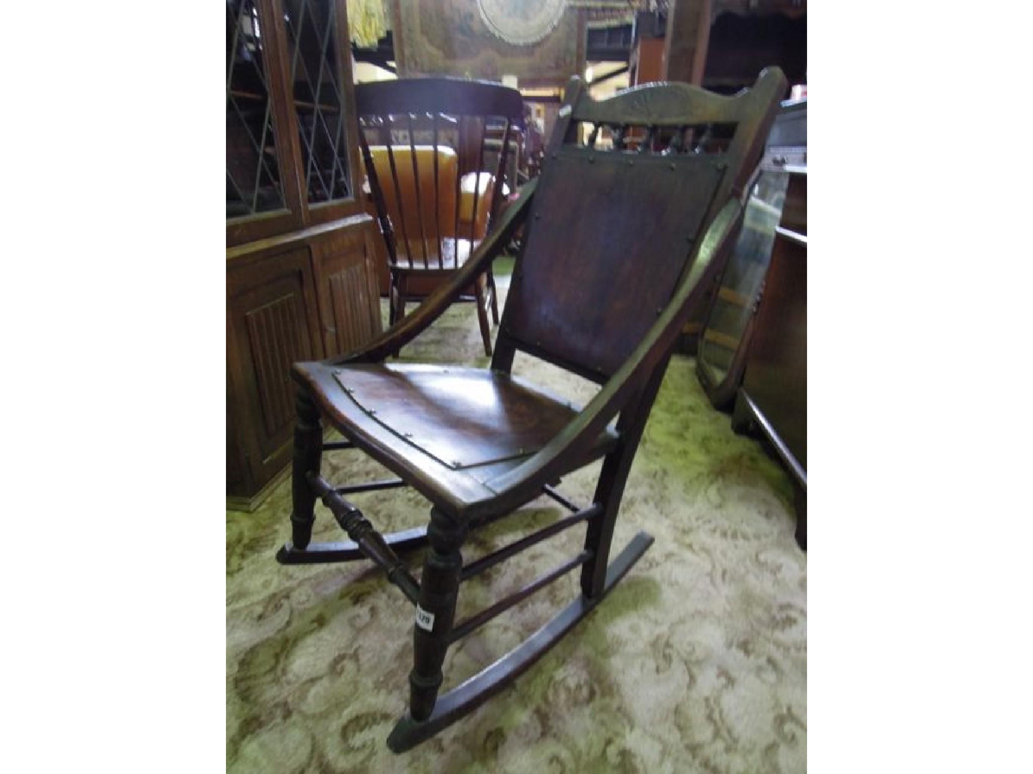 Appraisal: An Edwardian rocking chair with ply wood panelled seat and