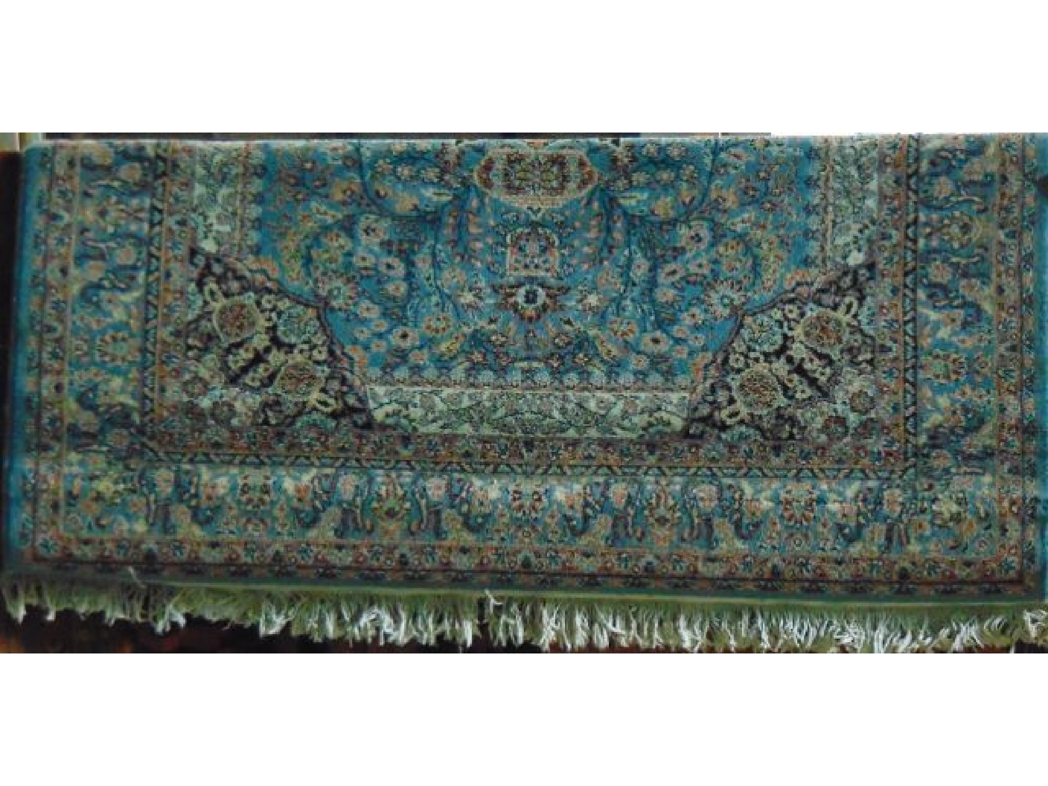 Appraisal: An extensive machine woven fringed wool rug with sky blue