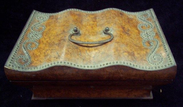 Appraisal: A Victorian walnut box the wavy lid decorated cut steel