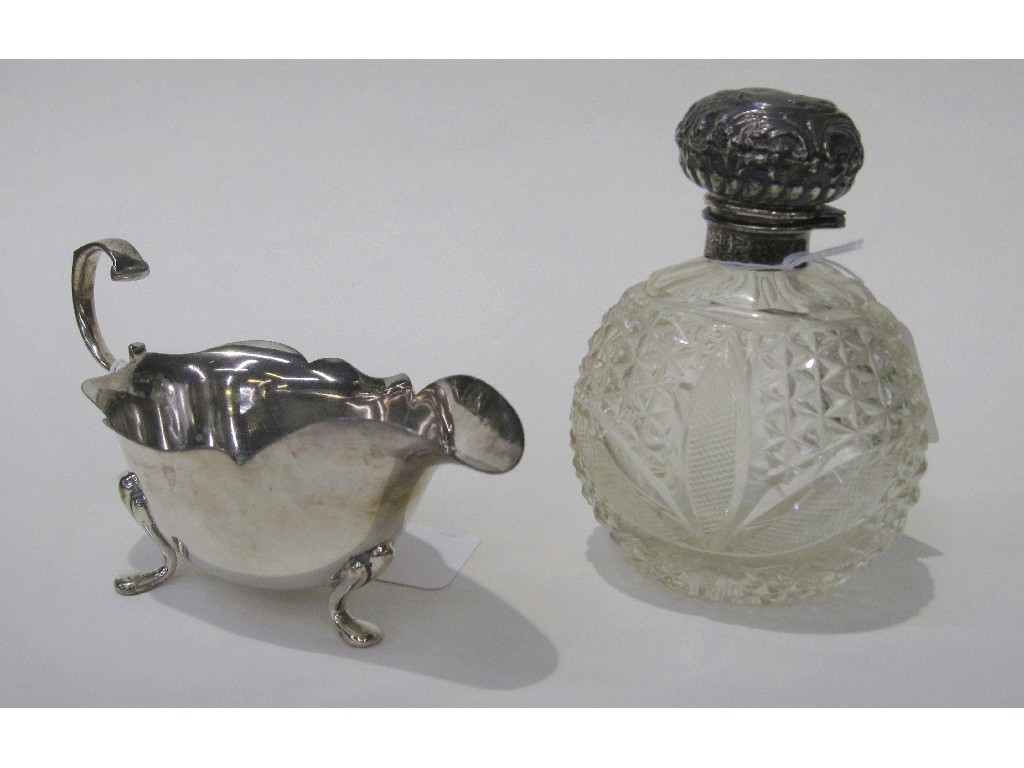 Appraisal: Lot comprising silver topped scent bottle and a sauce boat