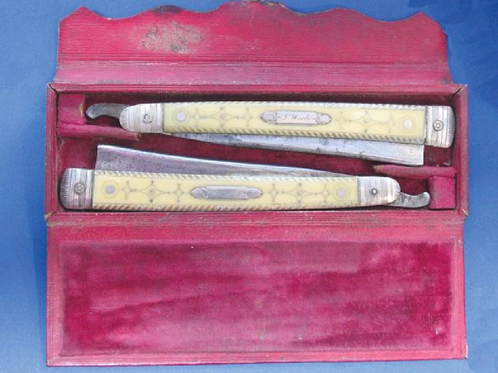 Appraisal: A PAIR OF GEORGE III CUT-THROAT RAZORS each with a