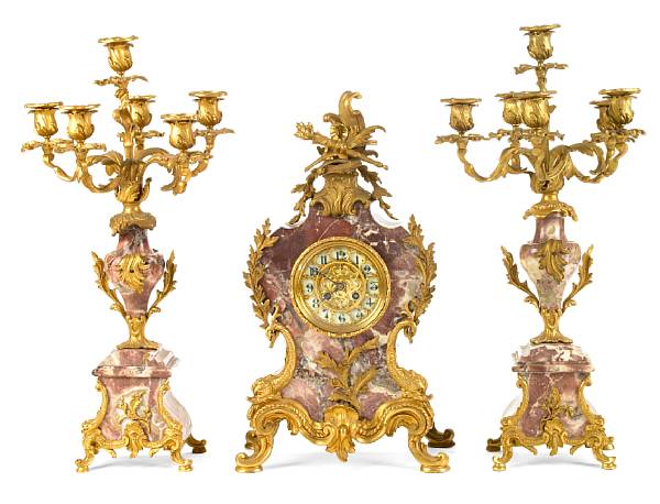 Appraisal: A Louis XVI style gilt bronze mounted marble clock garniture