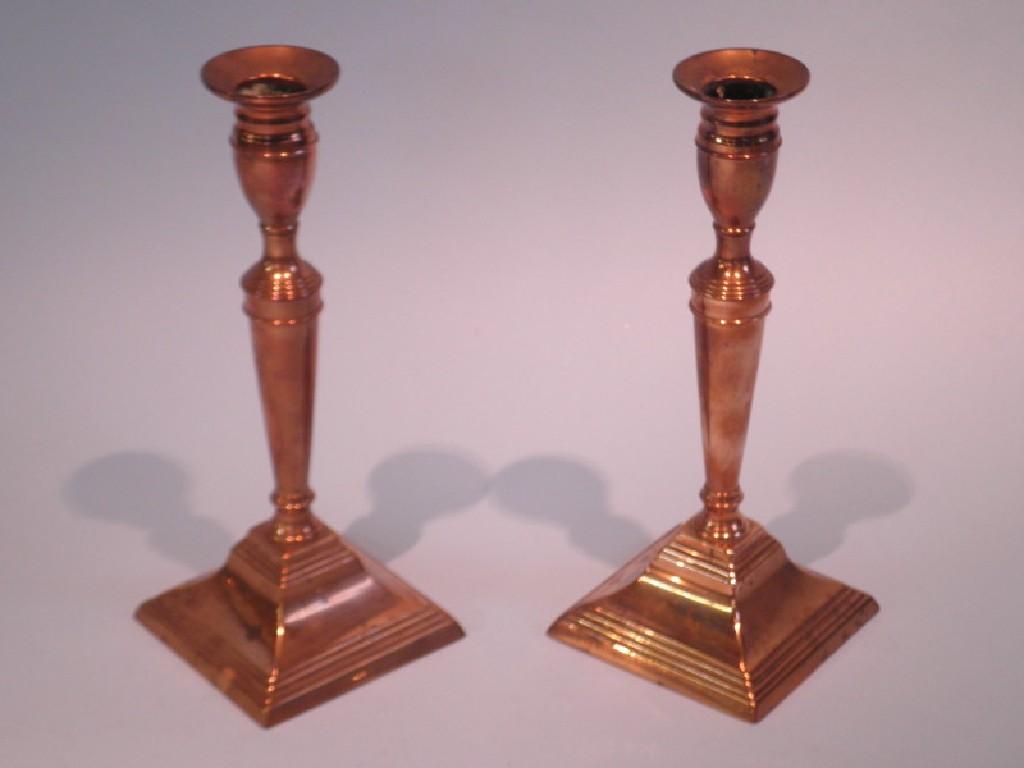 Appraisal: A pair of thC brass candlesticks each with tapering column