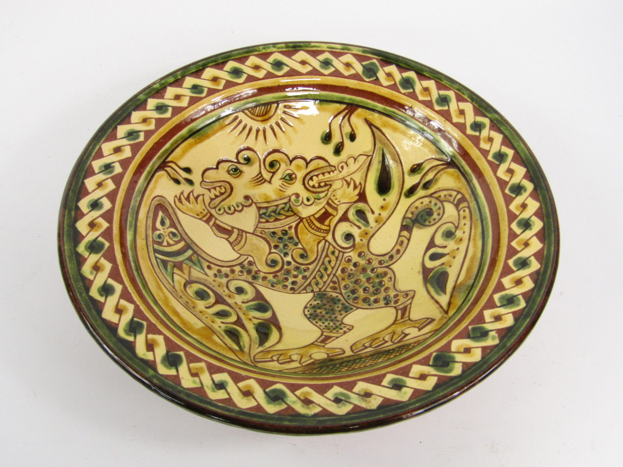 Appraisal: A Continental slipware dish decorated with a double headed dragon