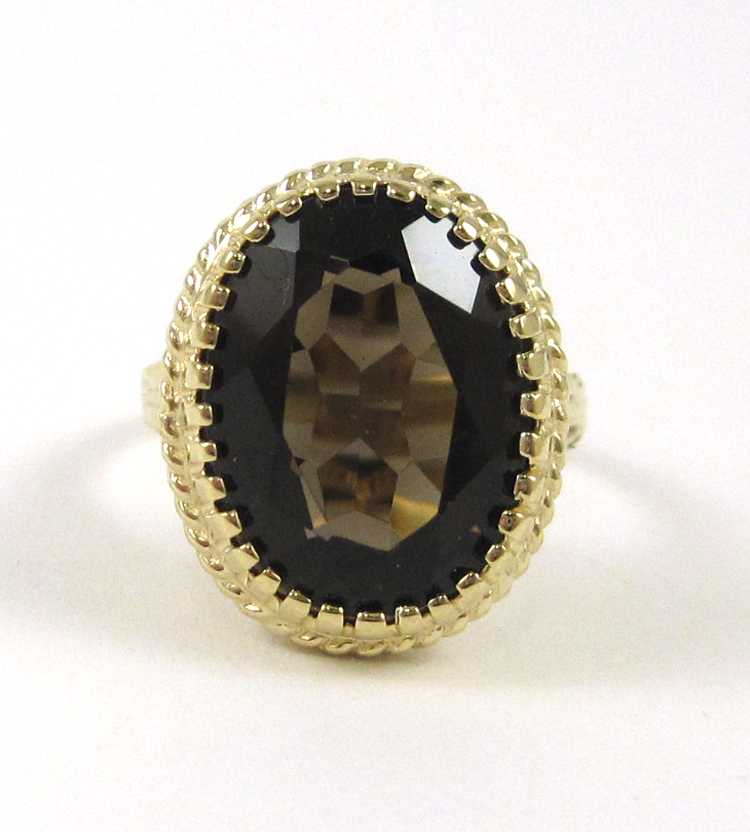 Appraisal: SMOKY QUARTZ AND TEN KARAT GOLD RING set with an