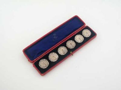 Appraisal: A cased set of six decorative buttons each one depicting