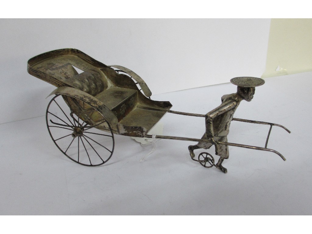 Appraisal: A Chinese white metal model of a rickshaw with driver