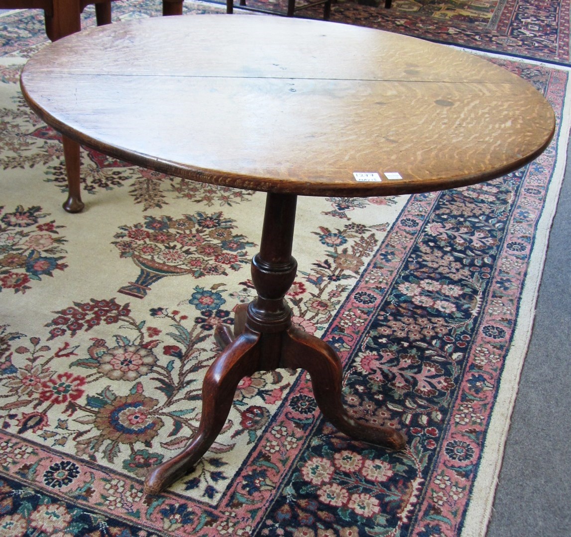 Appraisal: A George III oak tripod table the circular snap top