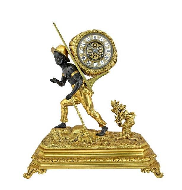 Appraisal: A gilt bronze clock with negro porter carrying the cotton