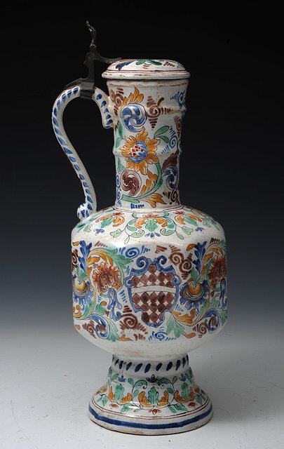 Appraisal: A DELFT POLYCHROME LIDDED JUG the central body of octagonal