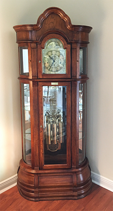 Appraisal: RIDGEWAY WALNUT CURIO GRANDFATHER CLOCK Arched pediment beveled glass front