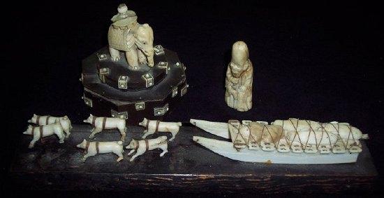 Appraisal: A carved bone model of a sled pulled by huskies