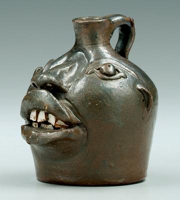 Appraisal: Brown Pottery miniature face jug stoneware with Albany slip glaze