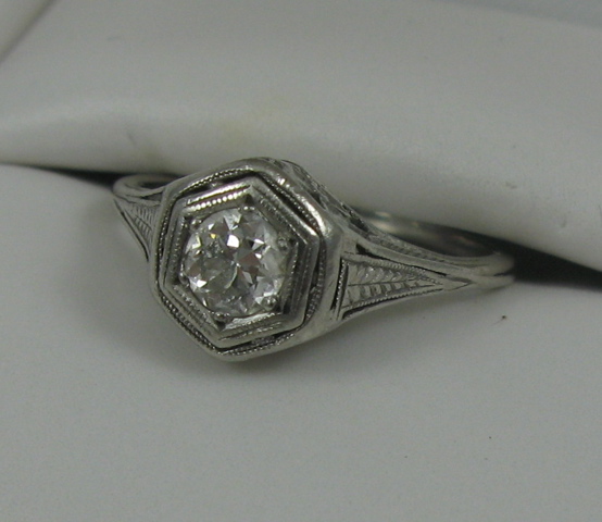 Appraisal: DIAMOND AND FOURTEEN KARAT WHITE GOLD SOLITAIRE RING set with