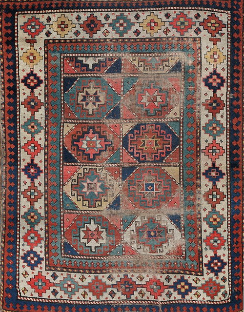 Appraisal: AN OLD GENJE RUG with two rows of star medallions