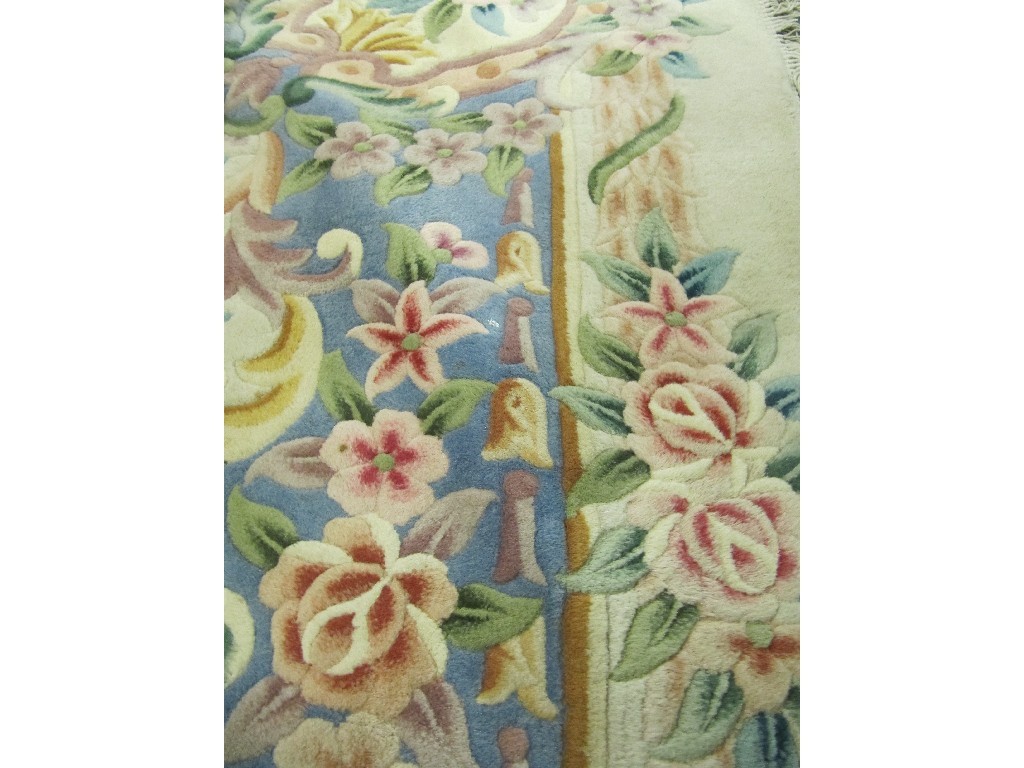 Appraisal: A large Chinese carpet with multi coloured floral decoration on