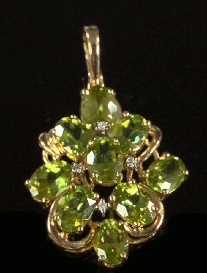 Appraisal: Fourteen-Karat Yellow Gold and Peridot Enhancer featuring nine oval-cut peridots