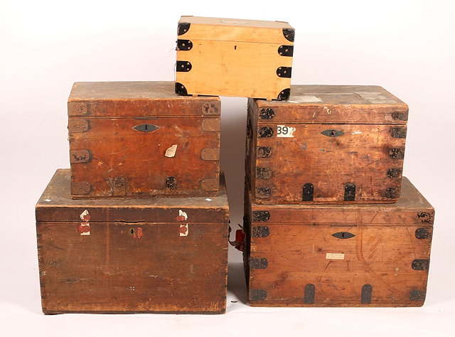 Appraisal: THREE METAL BOUND PINE TRAVELLING TRUNKS with lined interiors by