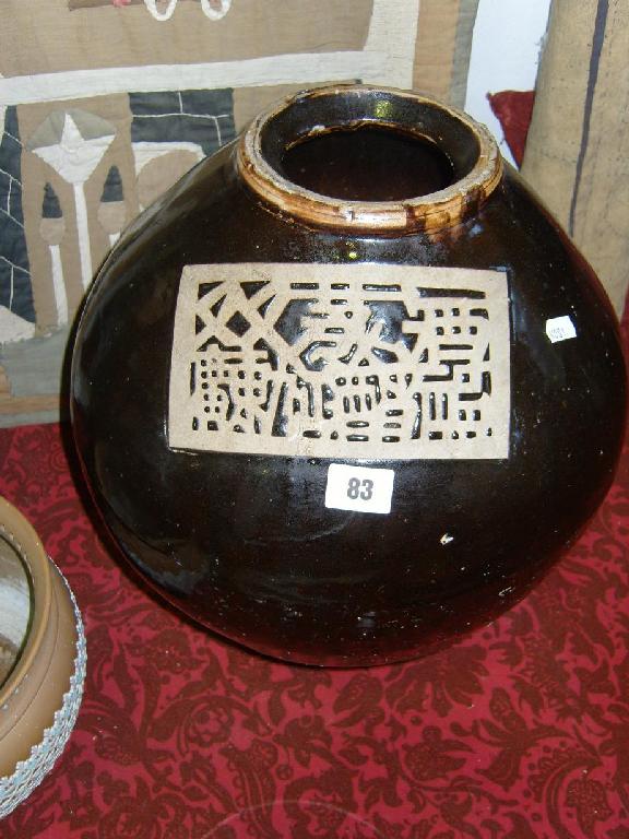 Appraisal: A large oriental vase with dark brown glaze and reserved