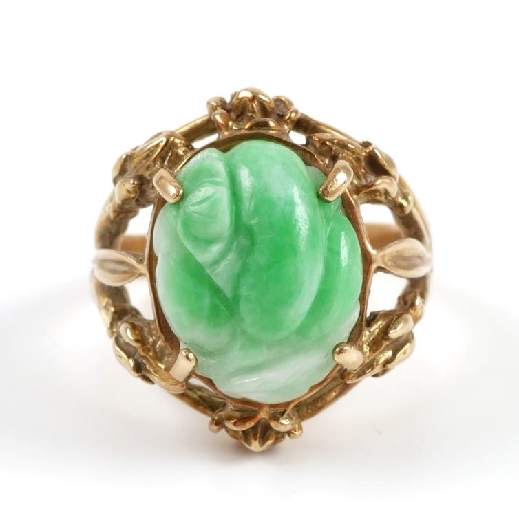 Appraisal: K yellow gold ring contains one carved cabochon of jade