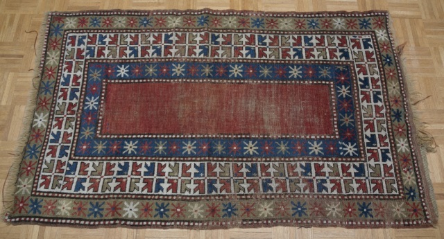 Appraisal: Caucasian Rug Red blue tan and white fields in alternating