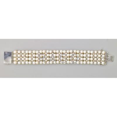 Appraisal: PEARL AND DIAMOND STRAP BRACELET Four rows of Japanese cultured