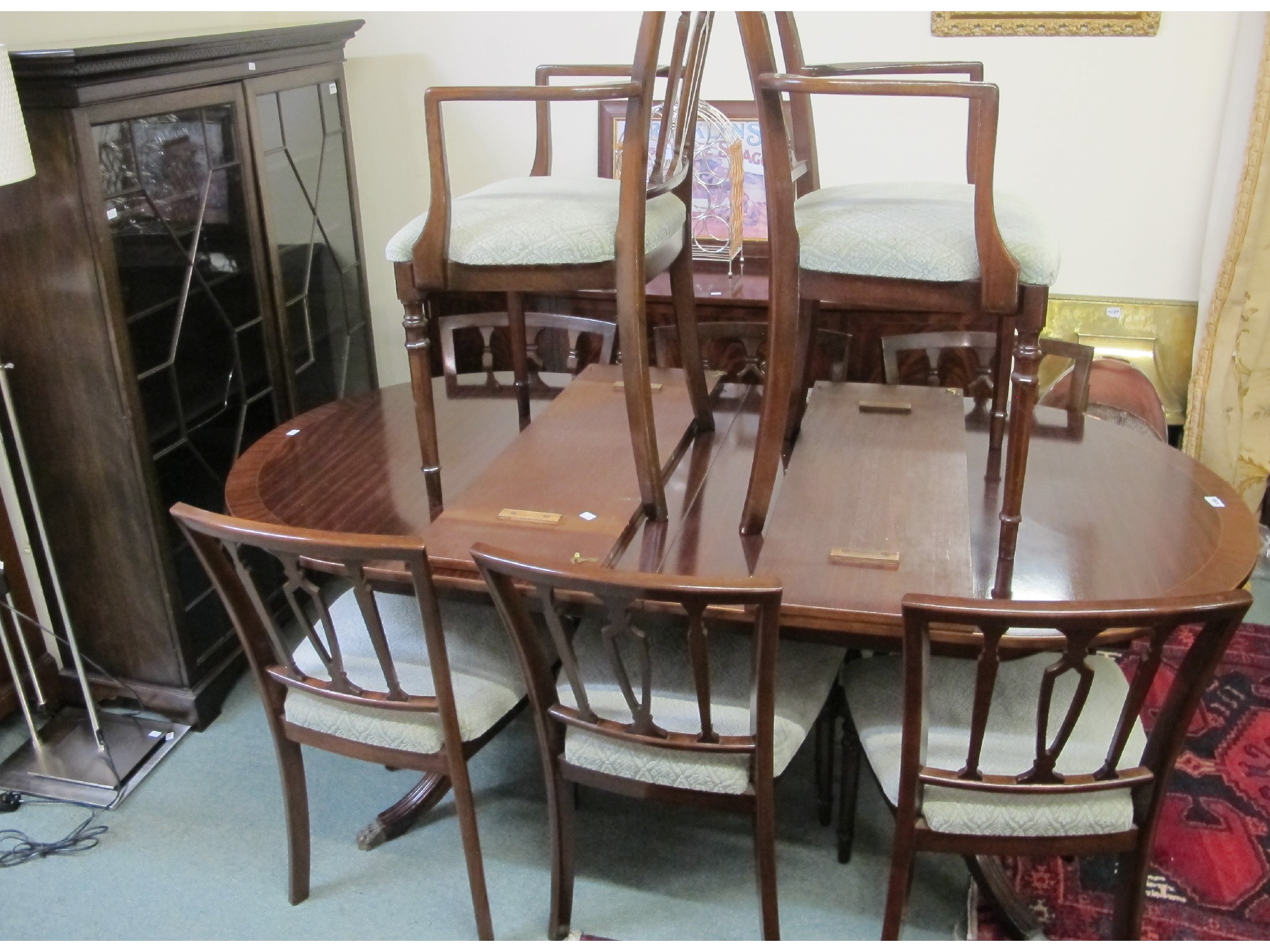 Appraisal: An extending inlaid mahogany dining table with two carvers and