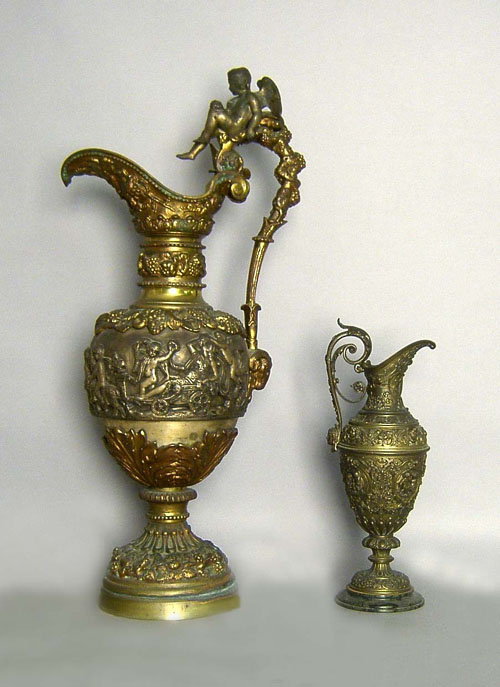 Appraisal: Two brass ewers early th c with putti figures tallest