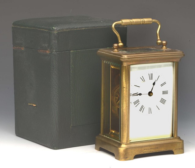 Appraisal: A BRASS CARRIAGE CLOCK with loop handle enamel dial and