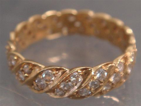 Appraisal: Unmarked YG diamond eternity band with serpentine rows of diamonds