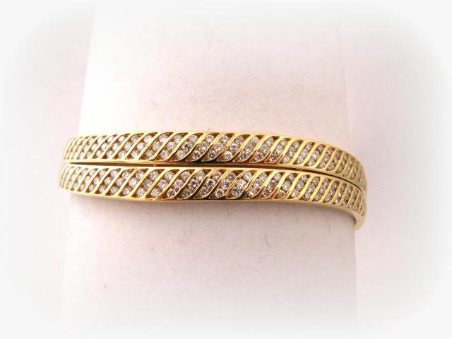 Appraisal: k yellow gold diamond double-wave design hinged bangle bracelet with