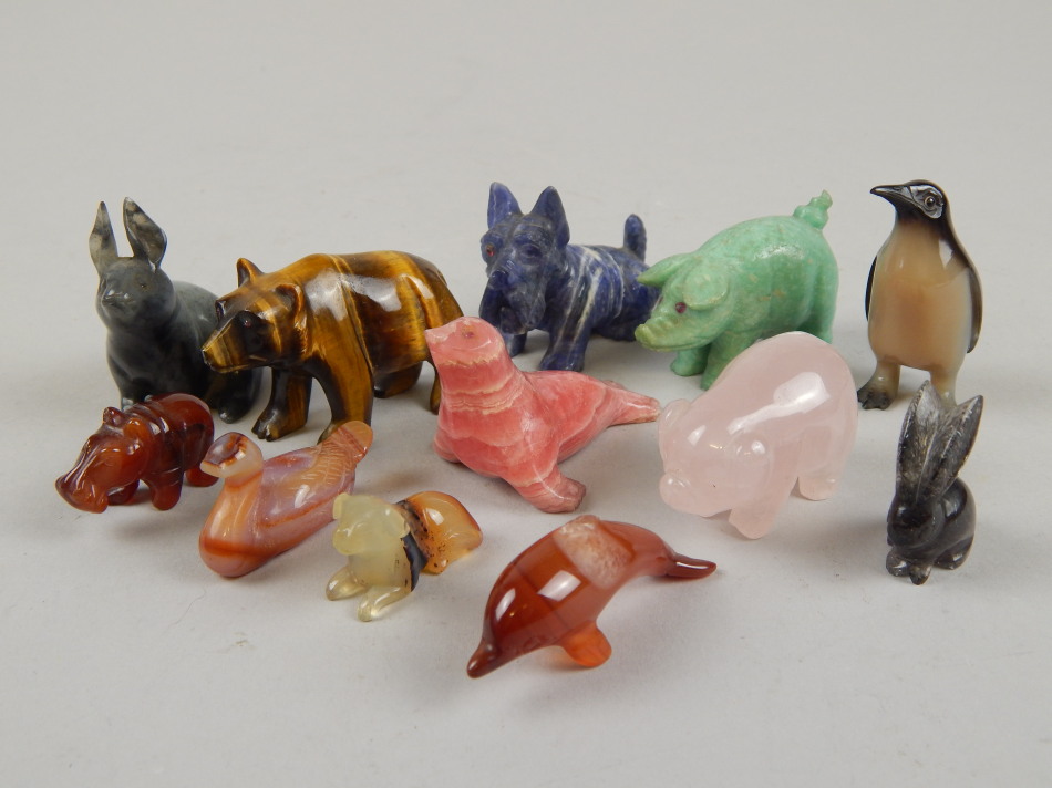 Appraisal: A collection of twelve carved hardstone animals including pigs penguin