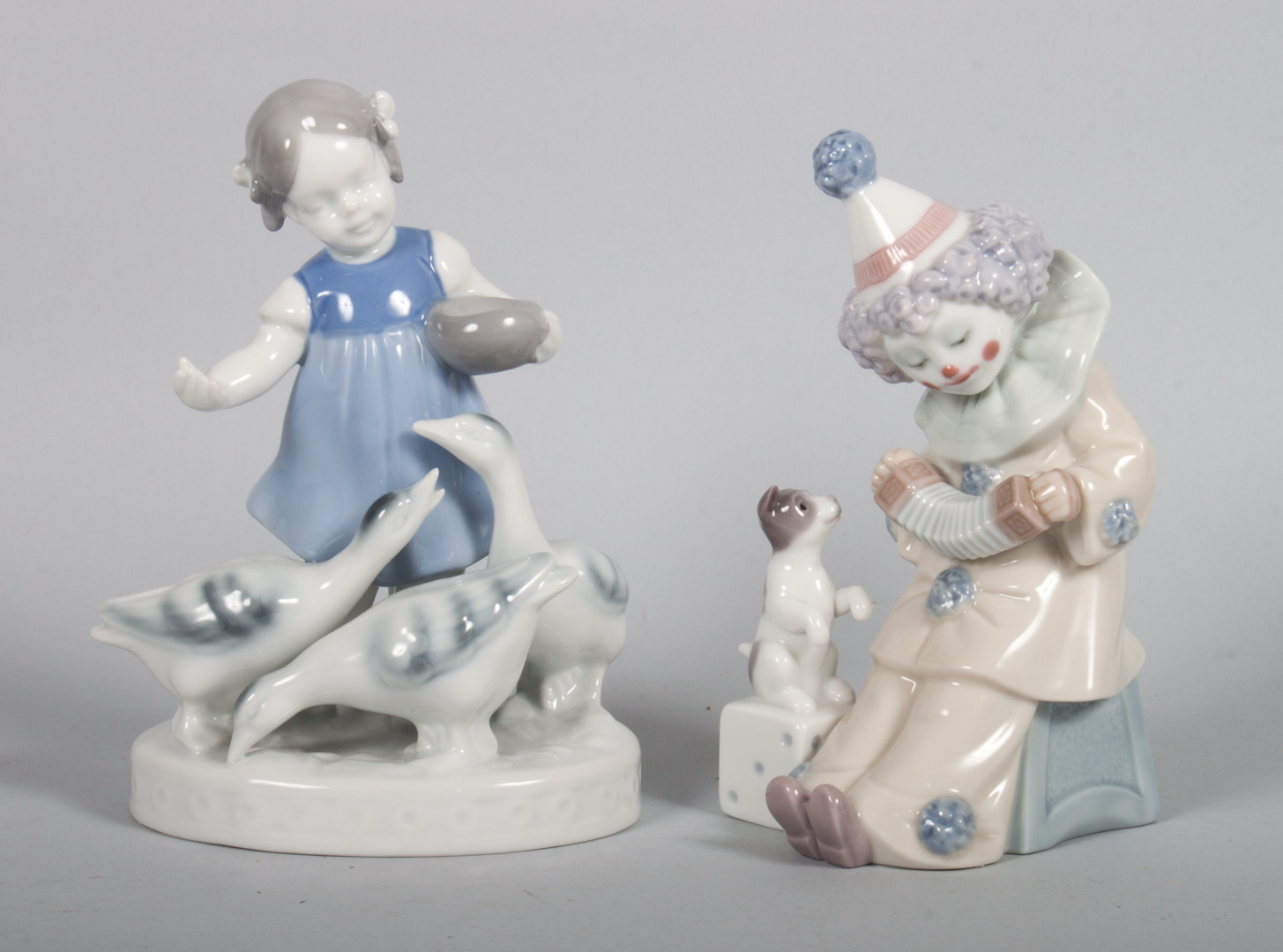 Appraisal: Two Continental porcelain figural groups Lladro Pierrot with Concertina in