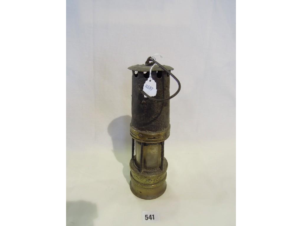 Appraisal: A coalminers lamp with cast iron top on a brass