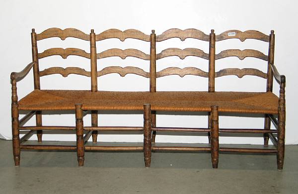 Appraisal: A French Provincial ladderback rush seat settee th century height