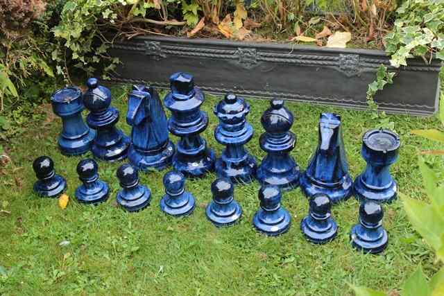 Appraisal: A BLUE AND BLACK GLAZED GARDEN CHESS SET The Kings