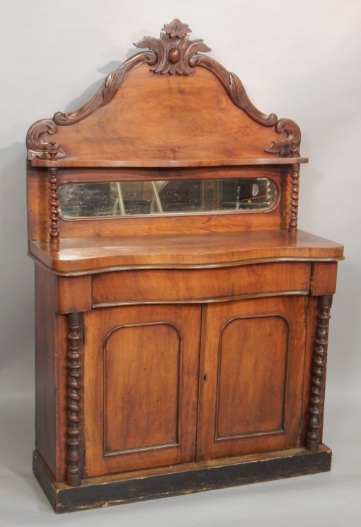 Appraisal: A Victorian walnut chiffonier the raised back with a shelf