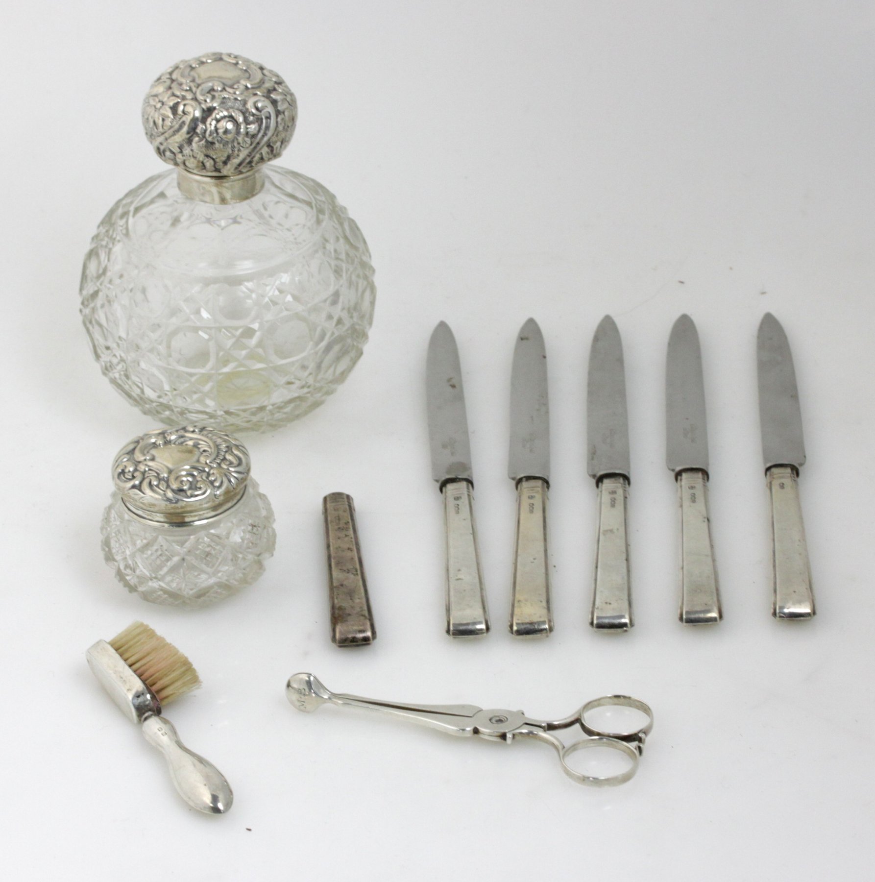 Appraisal: A silver mounted cut glass scent bottle the hinged cover