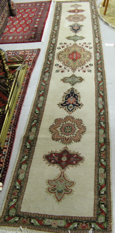 Appraisal: INDO-TABRIZ RUNNER repeating floral medallion design on plain ivory ground