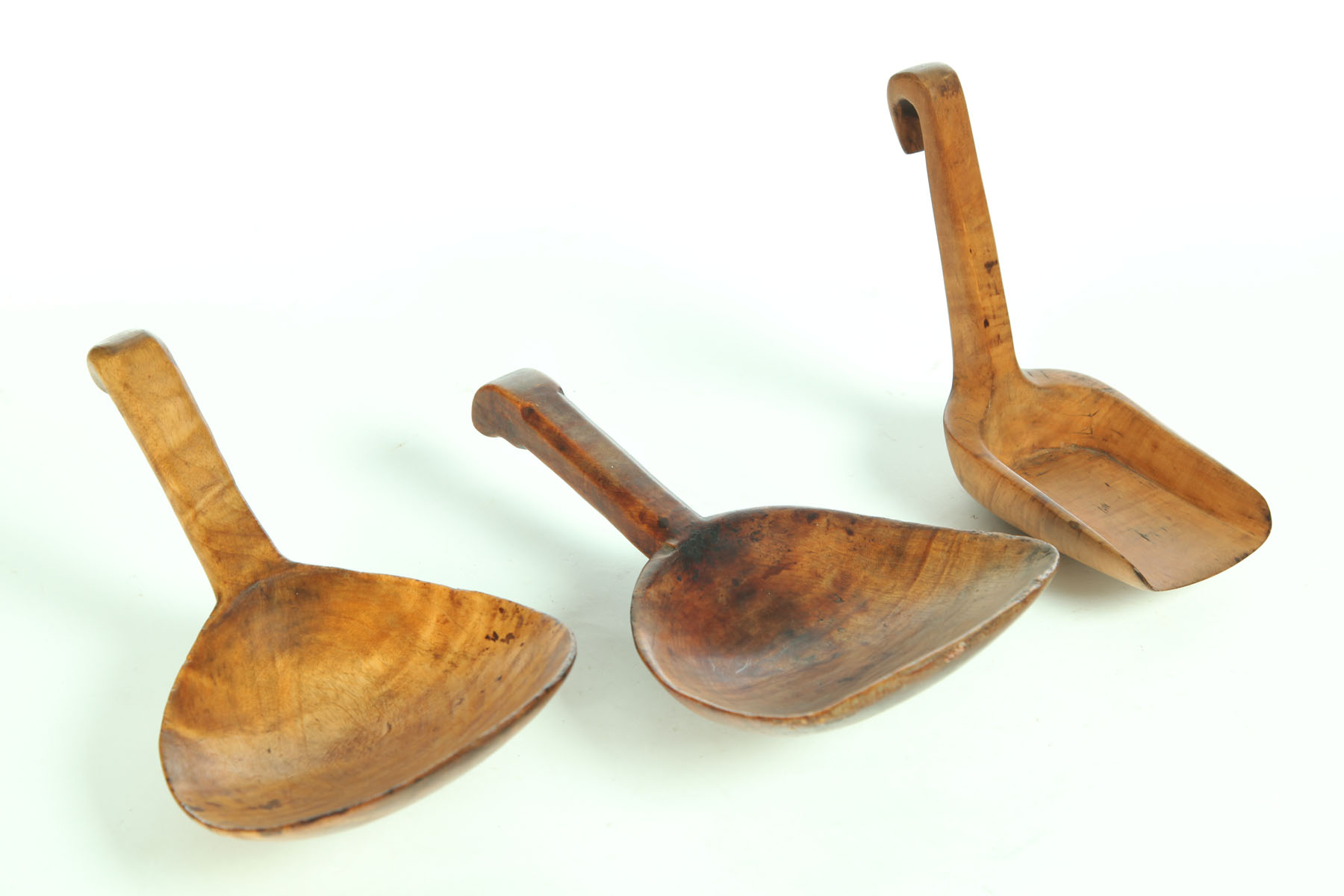 Appraisal: THREE BUTTER PADDLES American th century curly maple Varying curl