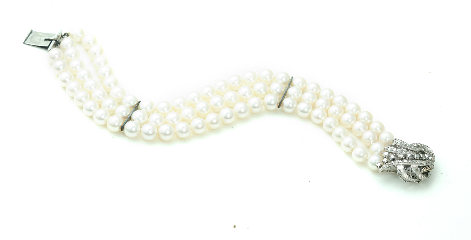 Appraisal: THREE-STRAND PEARL BRACELET Hong Kong ca Three strands of mm