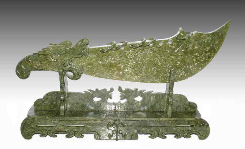 Appraisal: CHINESE CARVED STONE DRAGON SWORD Decorative sword carved from stone