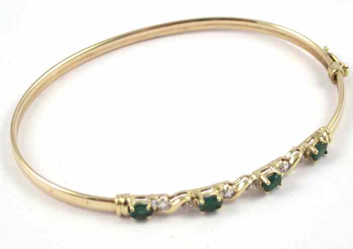 Appraisal: EMERALD DIAMOND AND TEN KARAT GOLD BANGLE set with four