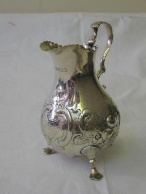 Appraisal: A VICTORIAN CREAM JUG of baluster form with leaf capped