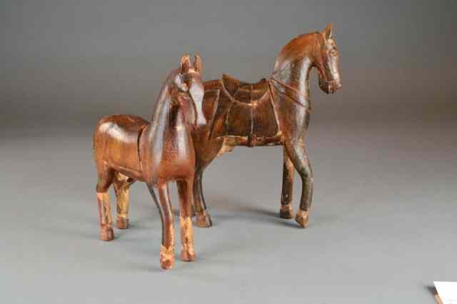 Appraisal: Pr Of Carved Wood Tang HorsesCarved to depict a horse