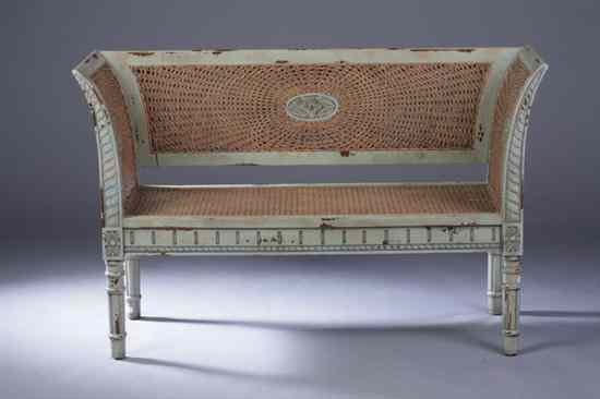 Appraisal: CONTINENTAL NEOCLASSICAL GREEN-PAINTED AND DOUBLE-CANED SETTEE late th century Sleigh-form